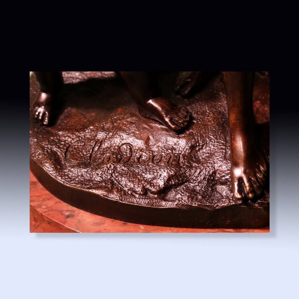 A 19th-century patinated bronze sculpture depicting Bacchanalian classical figures and cherubs mounted on a circular red marble base. View V