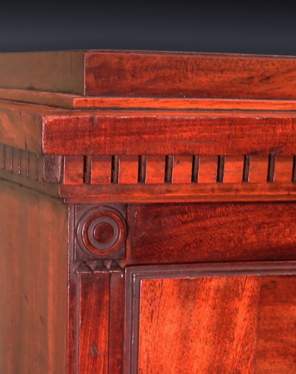A pair of matching George III period mahogany pedestal cupboards featuring flame mahogany panel doors and plinth bases. View IV