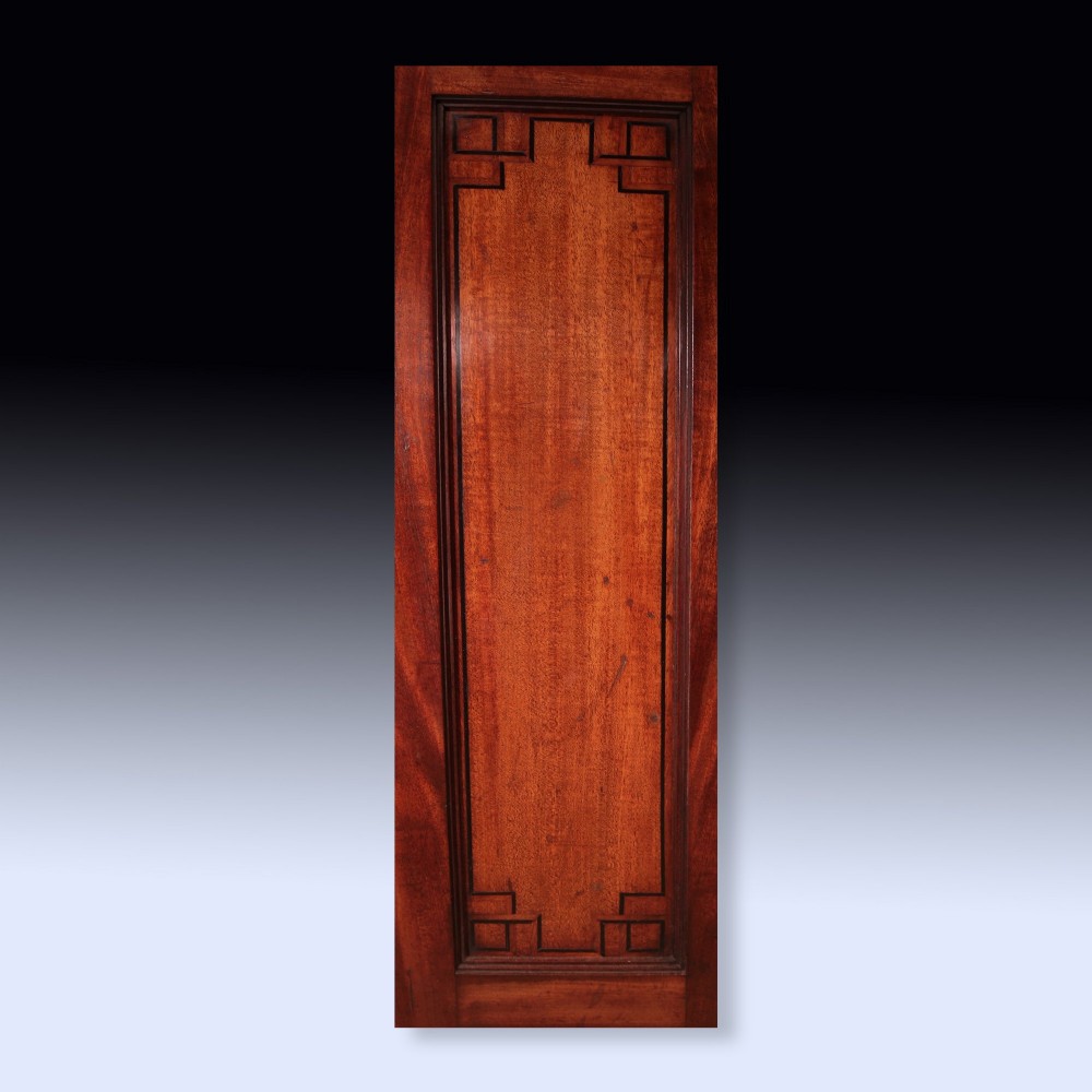 A pair of matching George III period mahogany pedestal cupboards featuring flame mahogany panel doors and plinth bases. View V
