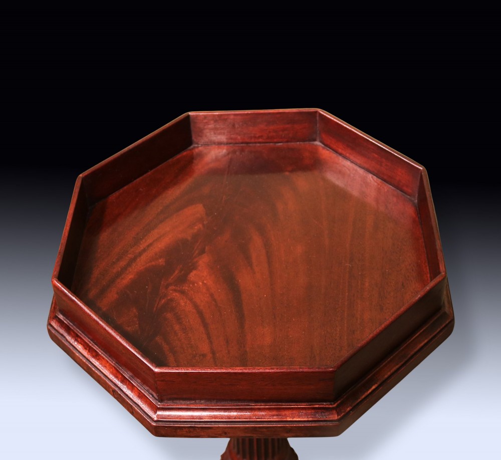 A dark mahogany tripod kettle stand featuring an octagonal tray top, fluted column stem, and carved acanthus leaf cabriole legs with scroll feet. View II