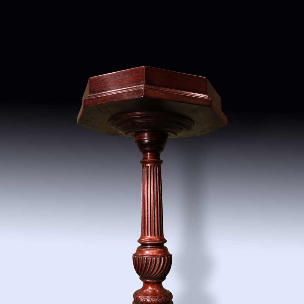 A dark mahogany tripod kettle stand featuring an octagonal tray top, fluted column stem, and carved acanthus leaf cabriole legs with scroll feet. View VI