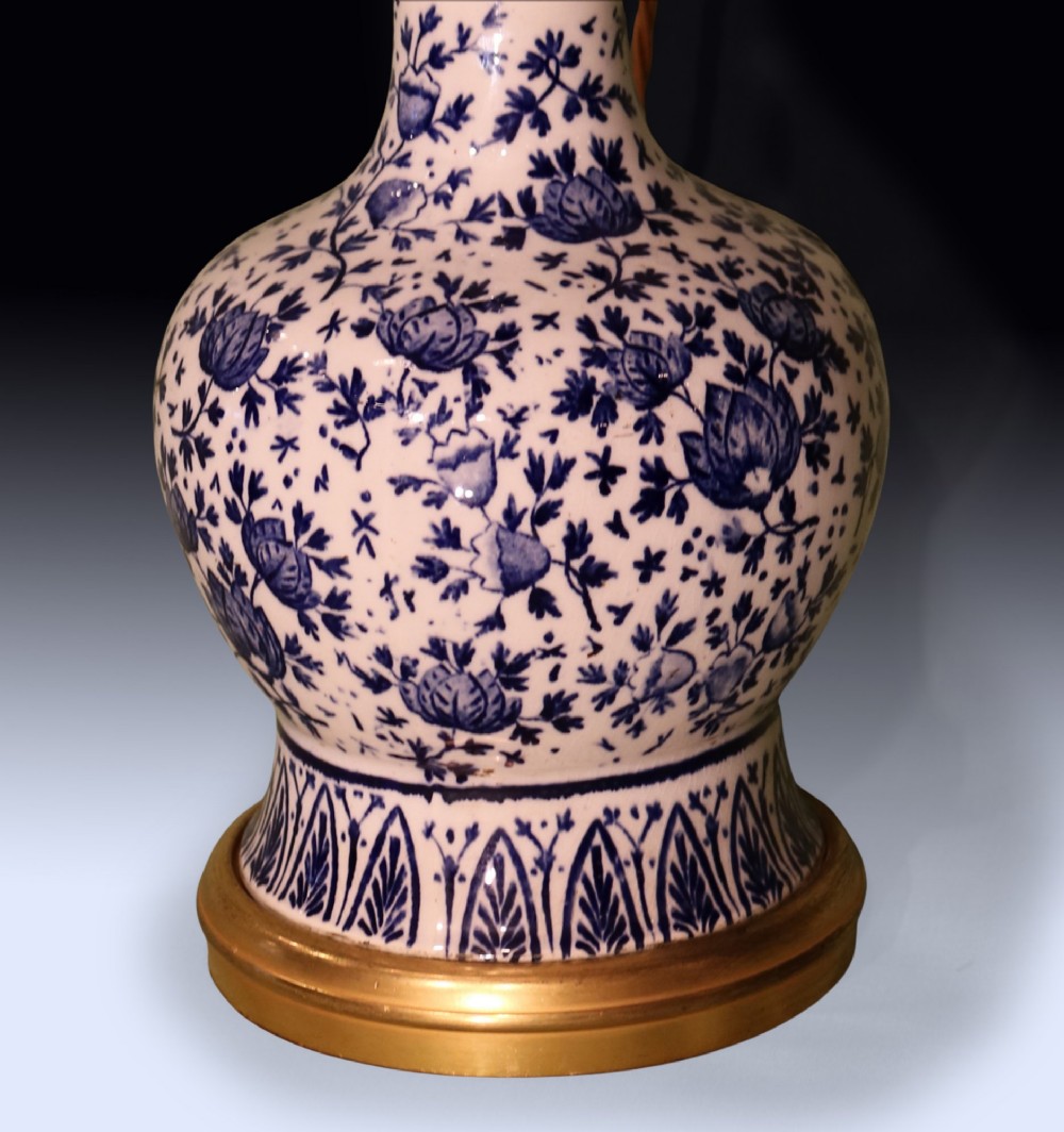 A pair of mid 19th century Chinese blue and white porcelain oil lamps with brass mounts and cream fabric shades. View IV