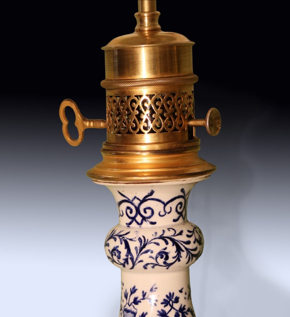 A pair of mid 19th century Chinese blue and white porcelain oil lamps with brass mounts and cream fabric shades. View V