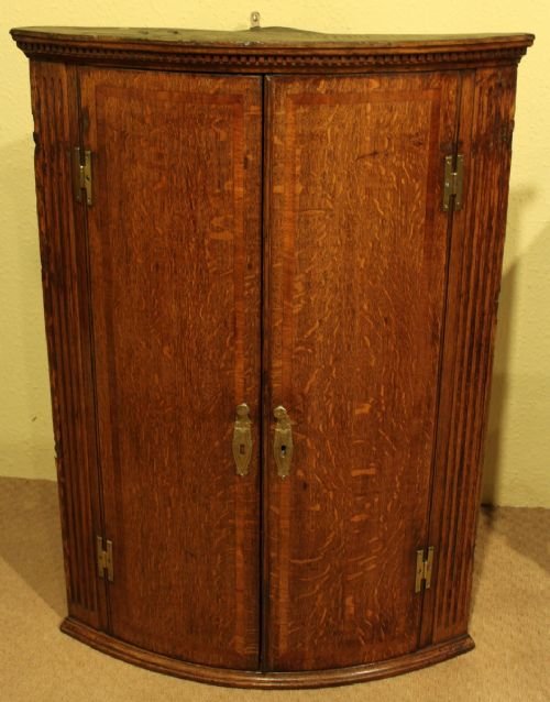 An Elegant Oak and Mahogany Corner Cupboard
