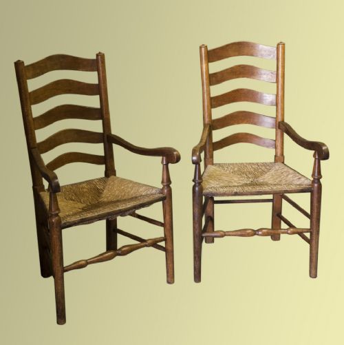 A Pair of Arts and Crafts Rush-seated Oak Ladderback Carver Chairs