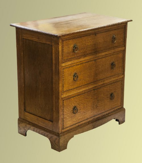 An Attractive Small Oak and Inlaid Chest of Three Drawers