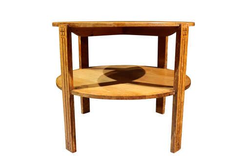 fig 1. A circular two-tier light oak Art Deco coffee table featuring four straight legs with carved geometric fluting.