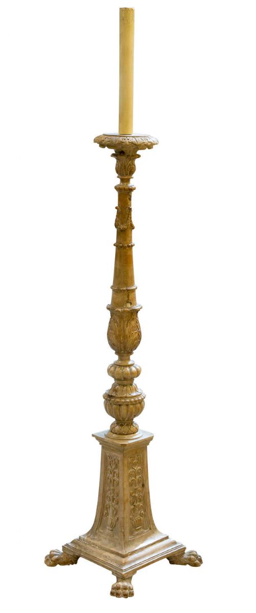 fig 1. A tall hand-carved pine torchere candlestick stand featuring a turned central column, carved leaf motifs, and a square pedestal base raised on sculpted feet.