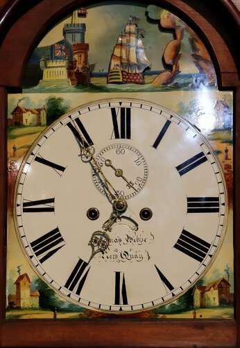 fig 2. A late 18th-century Welsh oak longcase clock with a swan-neck pediment, spiral side columns, and a hand-painted dial featuring a ship illustration.