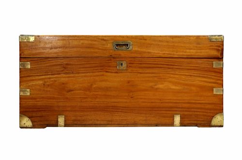 fig 1. A nineteenth-century camphor wood campaign trunk featuring polished warm timber grain and protective brass corner plates and drop handles.