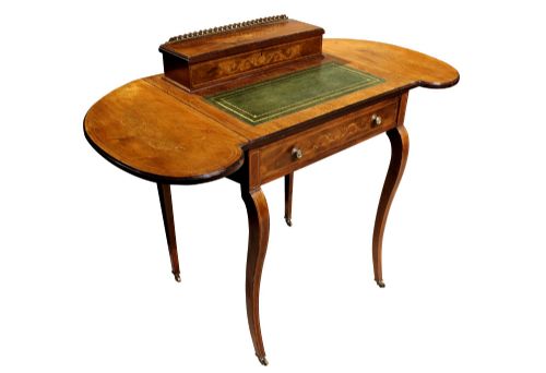 fig 1. An Edwardian rosewood writing table featuring a green leather writing surface, satinwood floral marquetry inlay, drop-leaf side panels, and a superstructure with brass gallery railing.