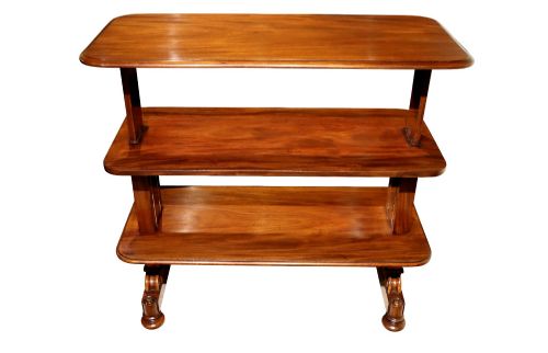 fig 2. A William IV polished mahogany three-tier buffet table featuring a mechanical rise and fall shelf structure supported by double upright columns and a carved trestle base.