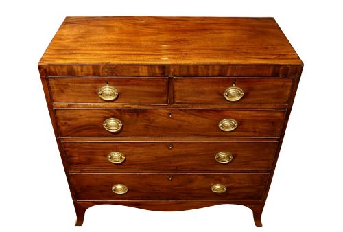 fig 2. A Regency mahogany chest of drawers featuring two short over three long drawers with oval brass handles and splayed feet.