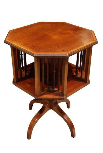 fig 1. An Edwardian octagonal mahogany revolving bookcase with open spindle sides set upon a turned pedestal stand with tripod legs.