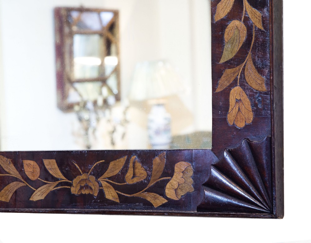 A mahogany and floral Dutch marquetry rectangular mirror with carved corner spandrels C1820 View V