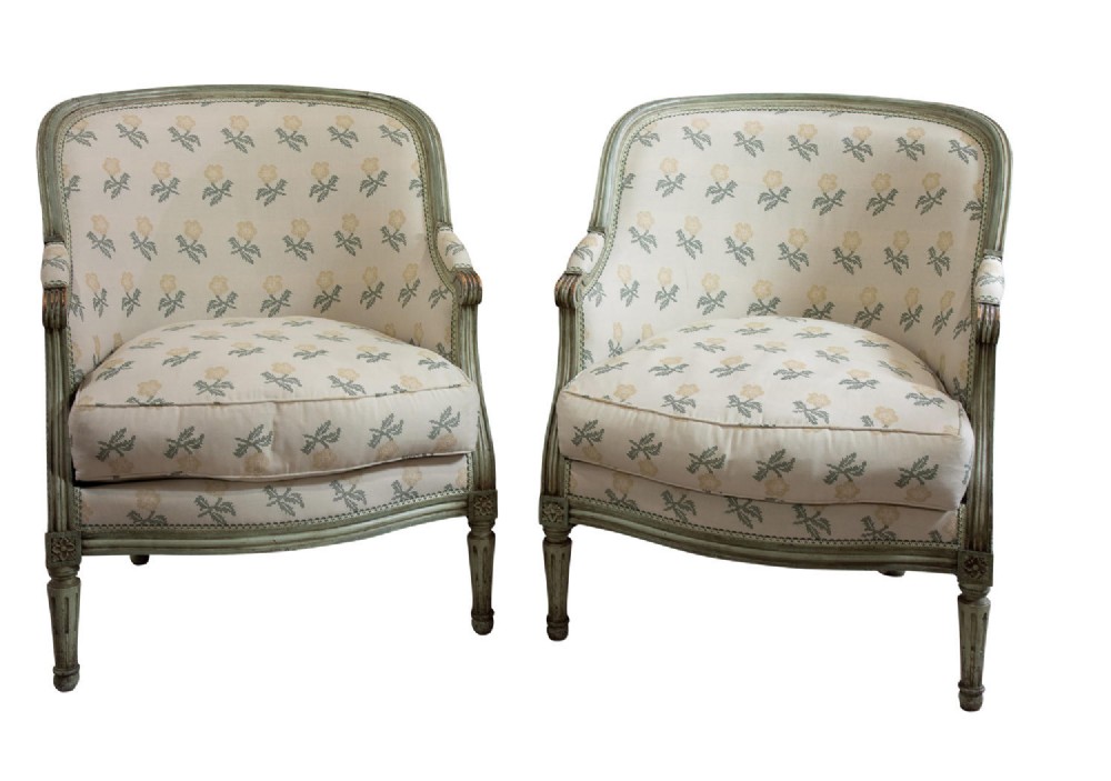 A pair of French beech framed painted tub chairs in the style of Louis XVI
