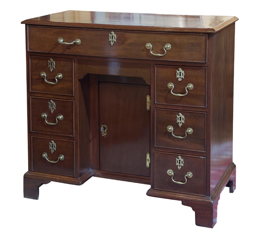 Striking George III mahogany kneehole desk with original hardware
