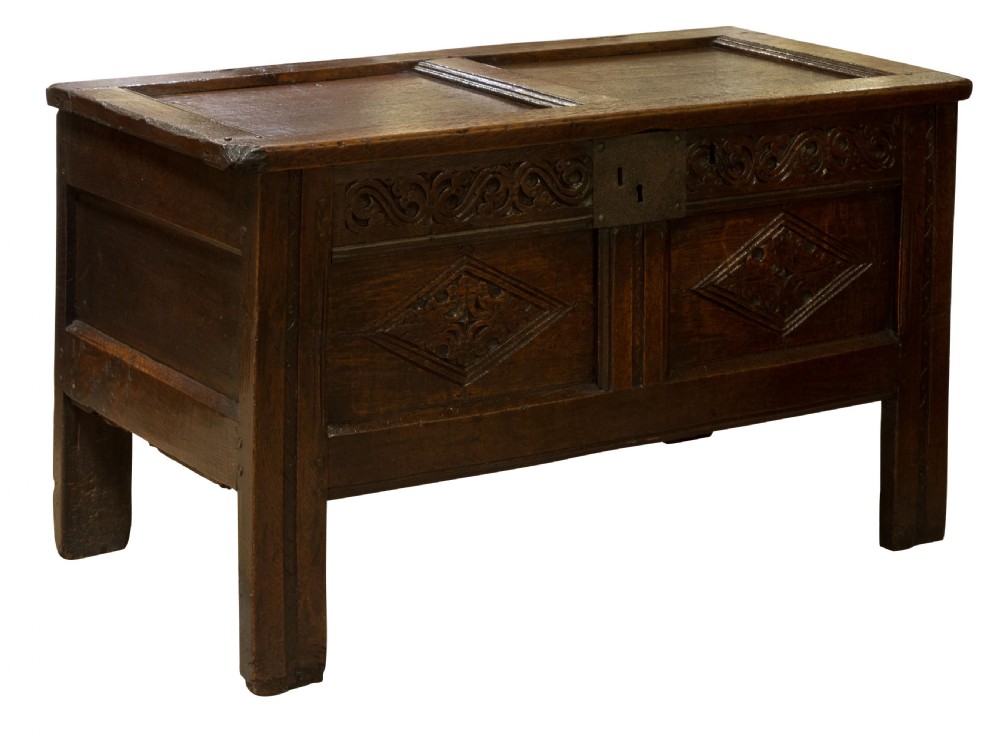 Mid 17thC panelled oak coffer with carved running strap work c1650