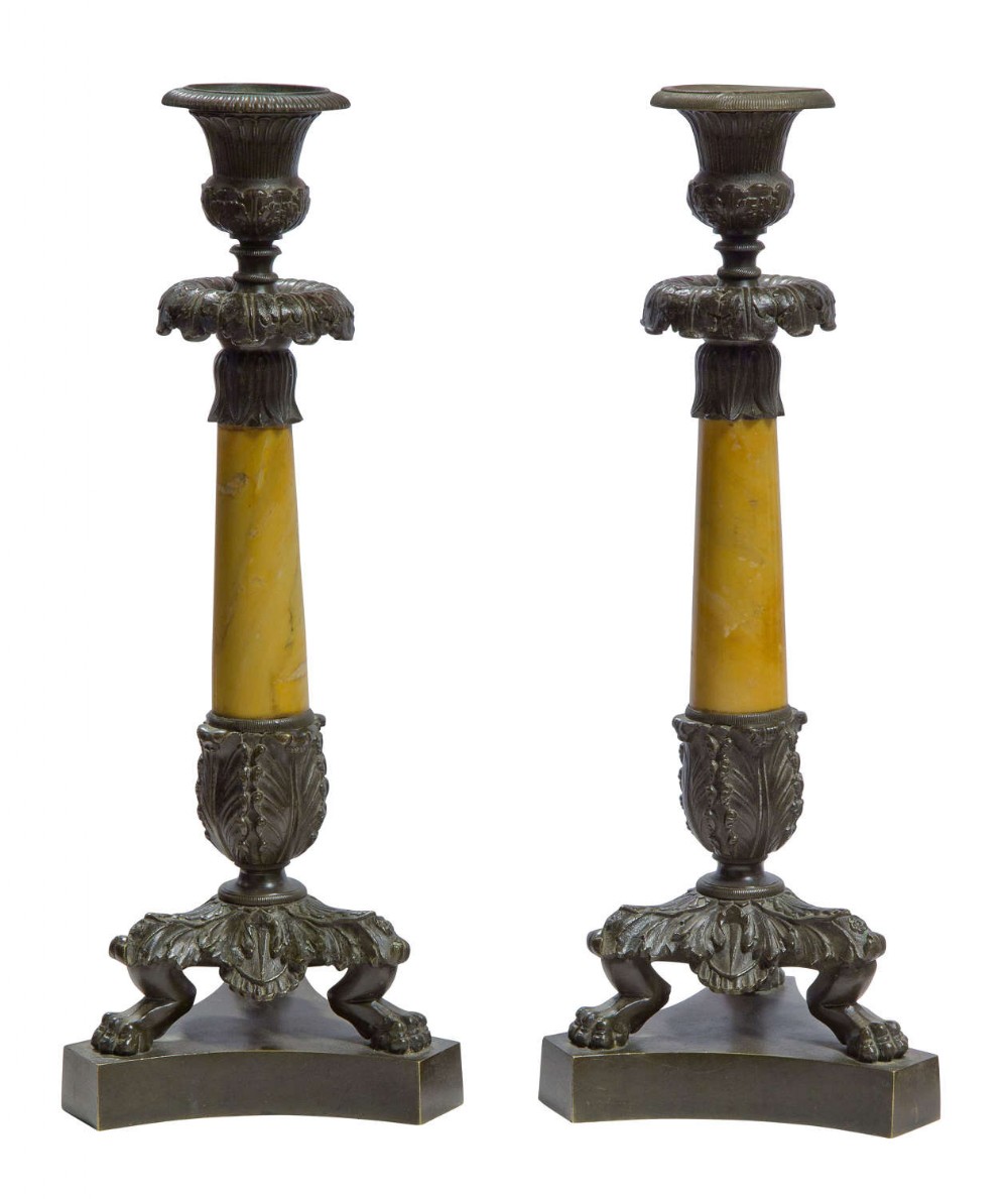A pair of Charles X bronze and sienna marble candlesticks