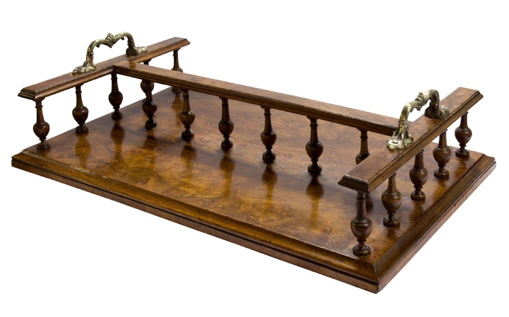 A Victorian figured walnut twin section book tray