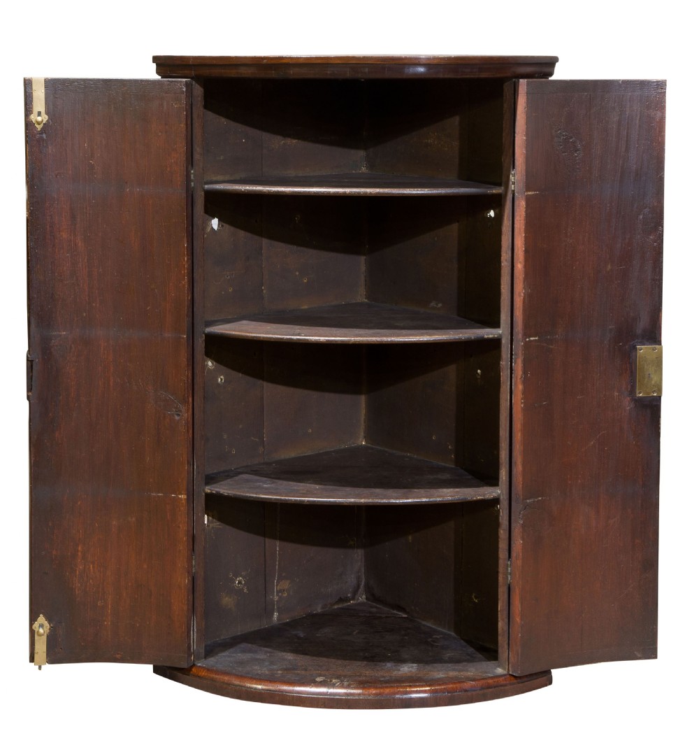 Early George III mahogany bow fronted corner cupboard View II