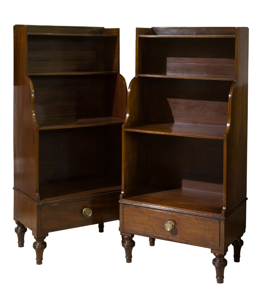 A pair of mahogany George III style waterfall bookcases