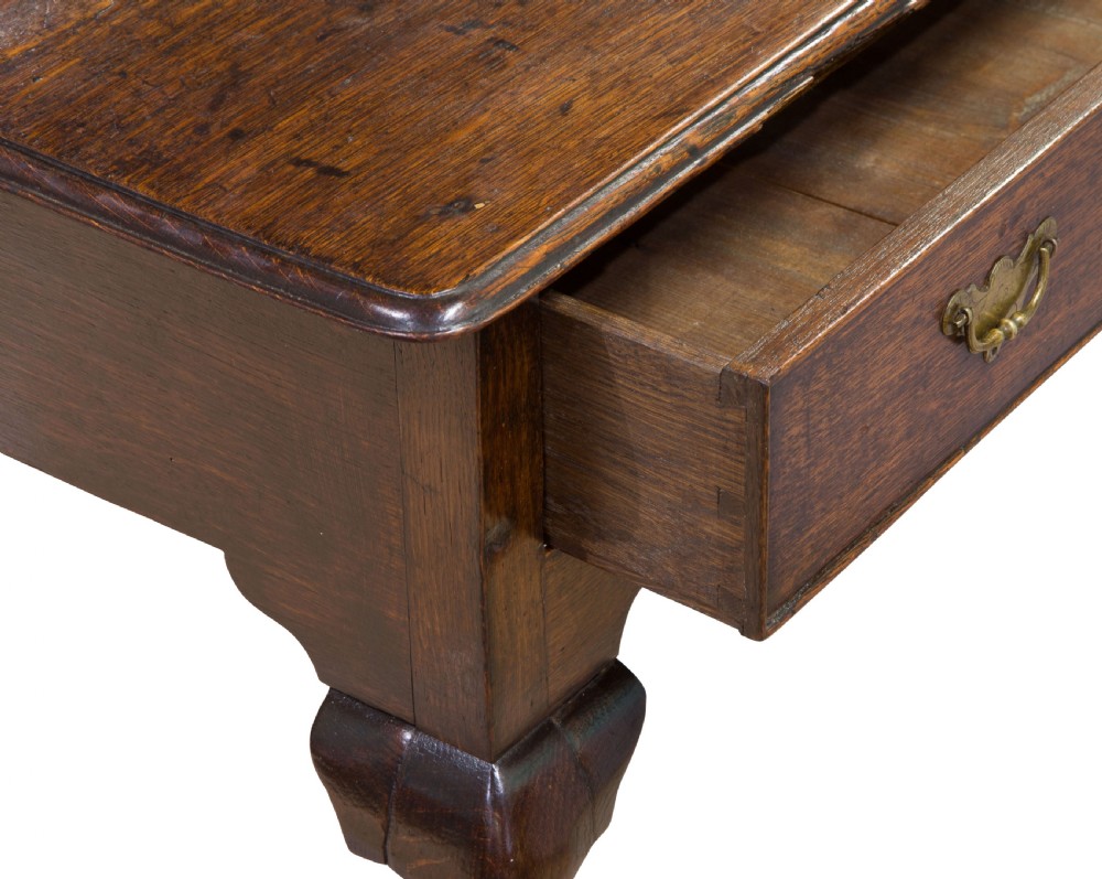 A George II Oak single drawer side table with original brass handles View VI