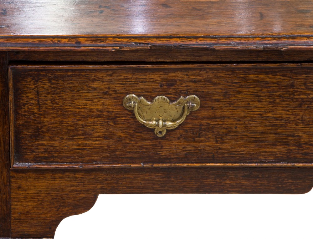 A George II Oak single drawer side table with original brass handles View VII