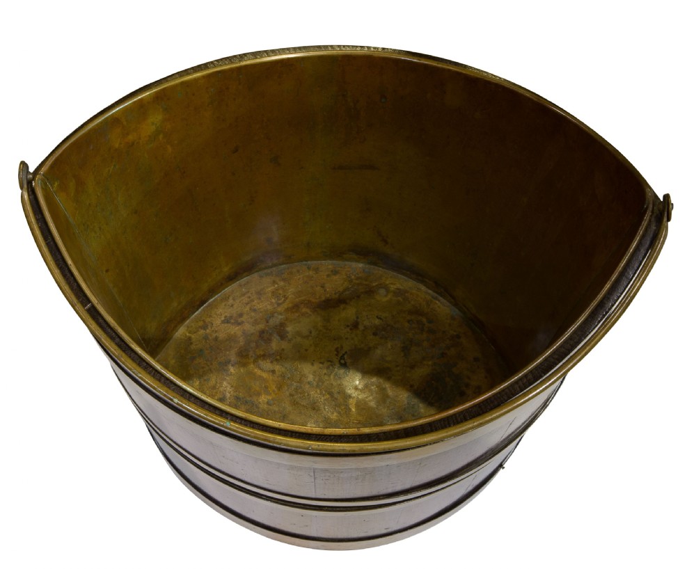 A late Georgian coopered mahogany bucket featuring brass horizontal banding, a removable inner brass liner, and a brass swing handle. View IV