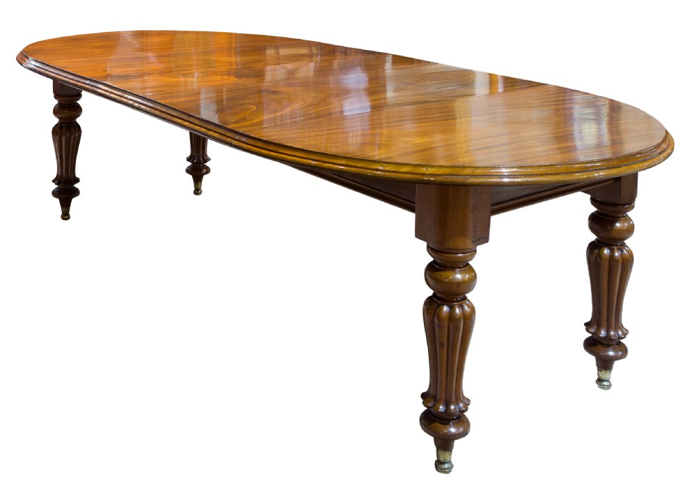 An early Victorian mahogany circular wind out extending dining table