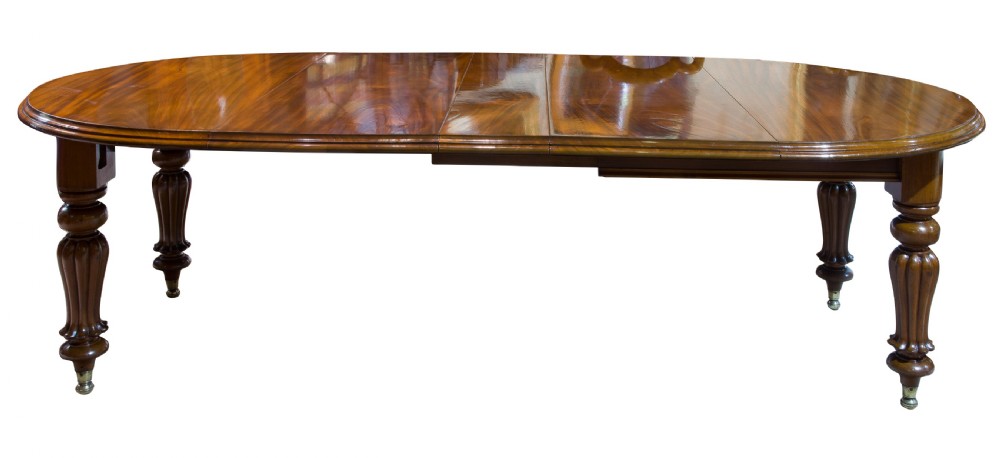 An early Victorian mahogany circular wind out extending dining table View II