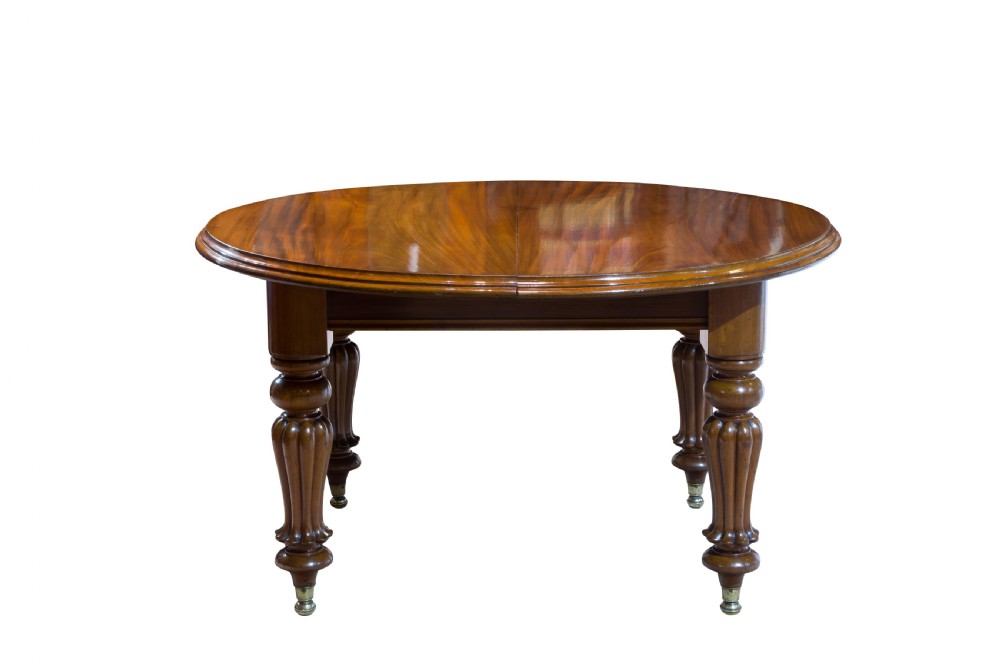 An early Victorian mahogany circular wind out extending dining table View III