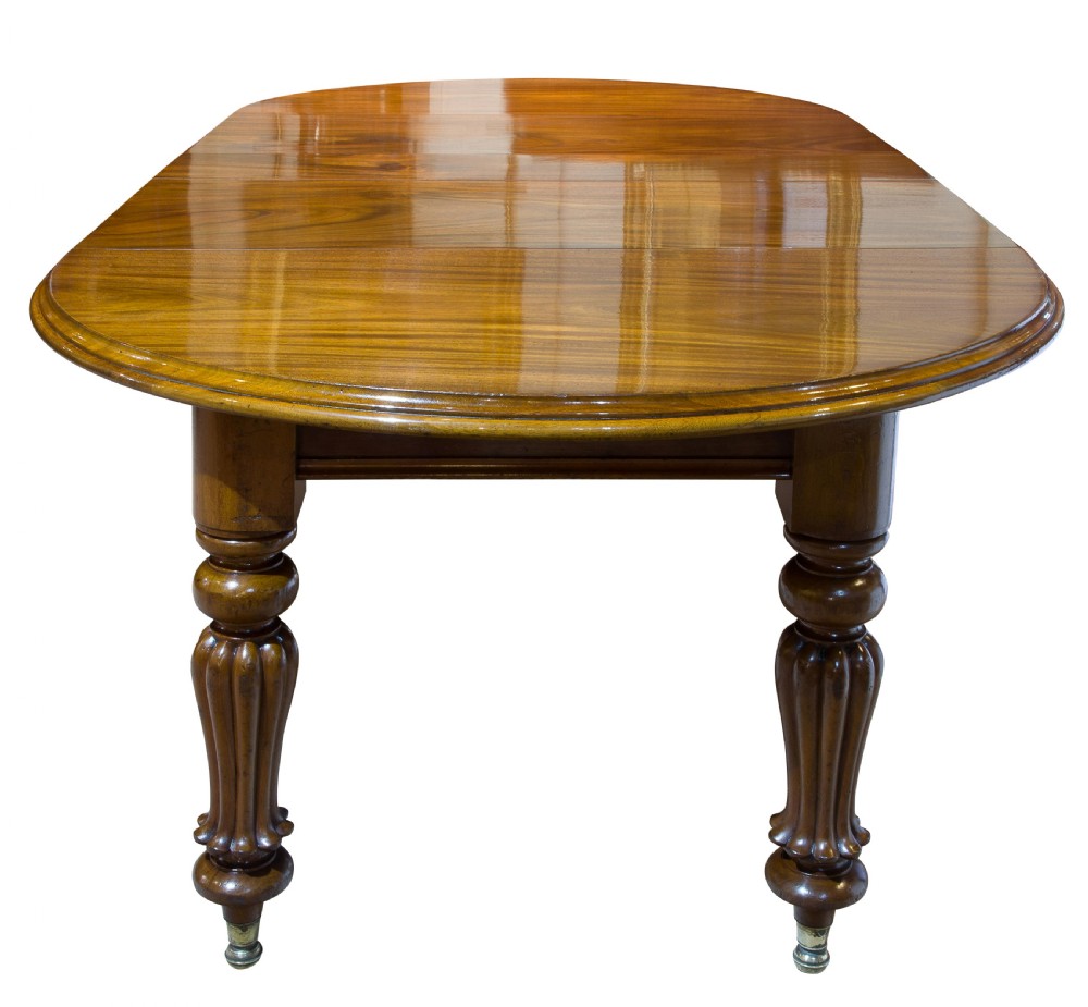 An early Victorian mahogany circular wind out extending dining table View IV