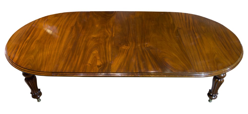 An early Victorian mahogany circular wind out extending dining table View V