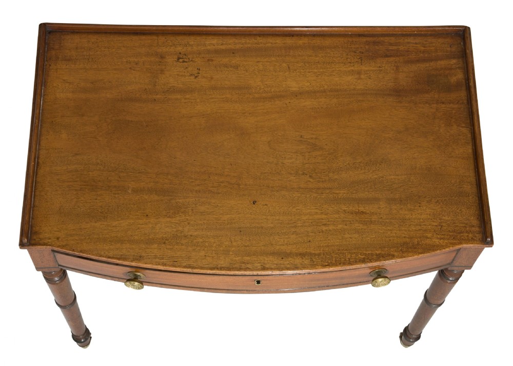 A George III mahogany bow fronted side table View VI
