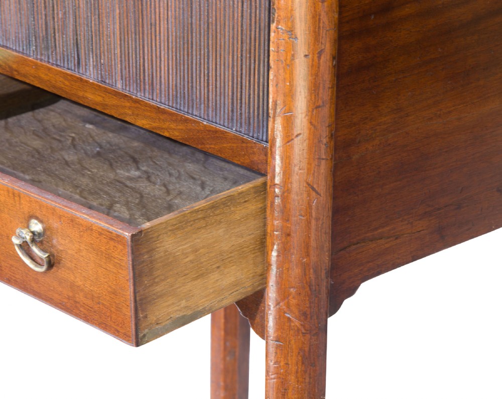 A George III mahogany tambour night stand featuring a cutout gallery top, a slatted sliding door, a single lower drawer with brass handles, and square legs. View III