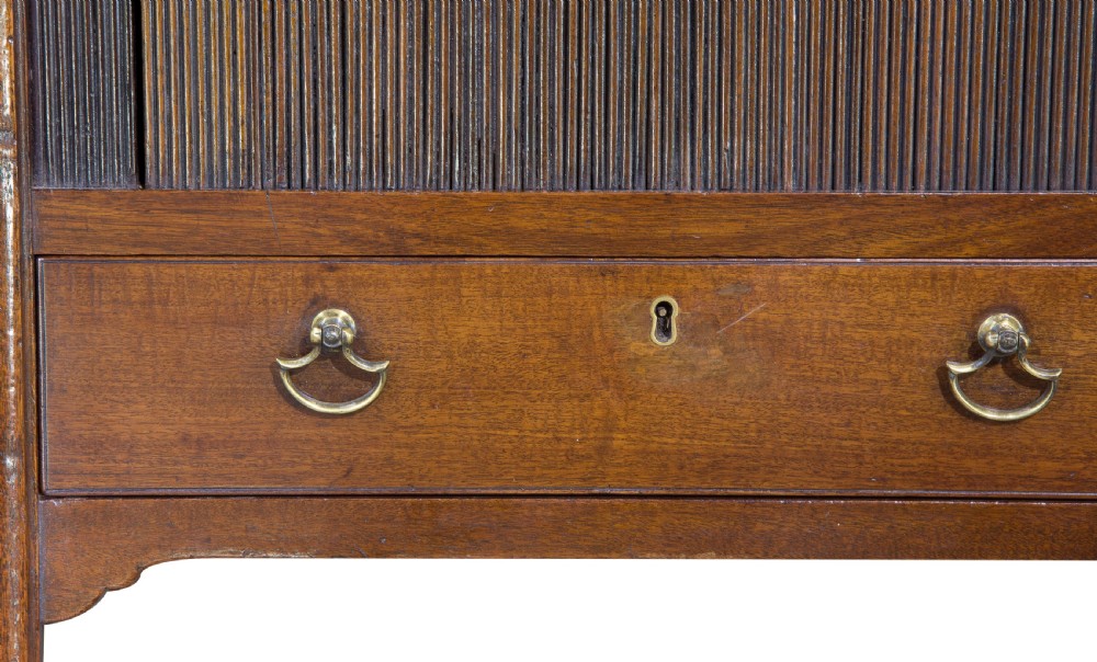 A George III mahogany tambour night stand featuring a cutout gallery top, a slatted sliding door, a single lower drawer with brass handles, and square legs. View VIII