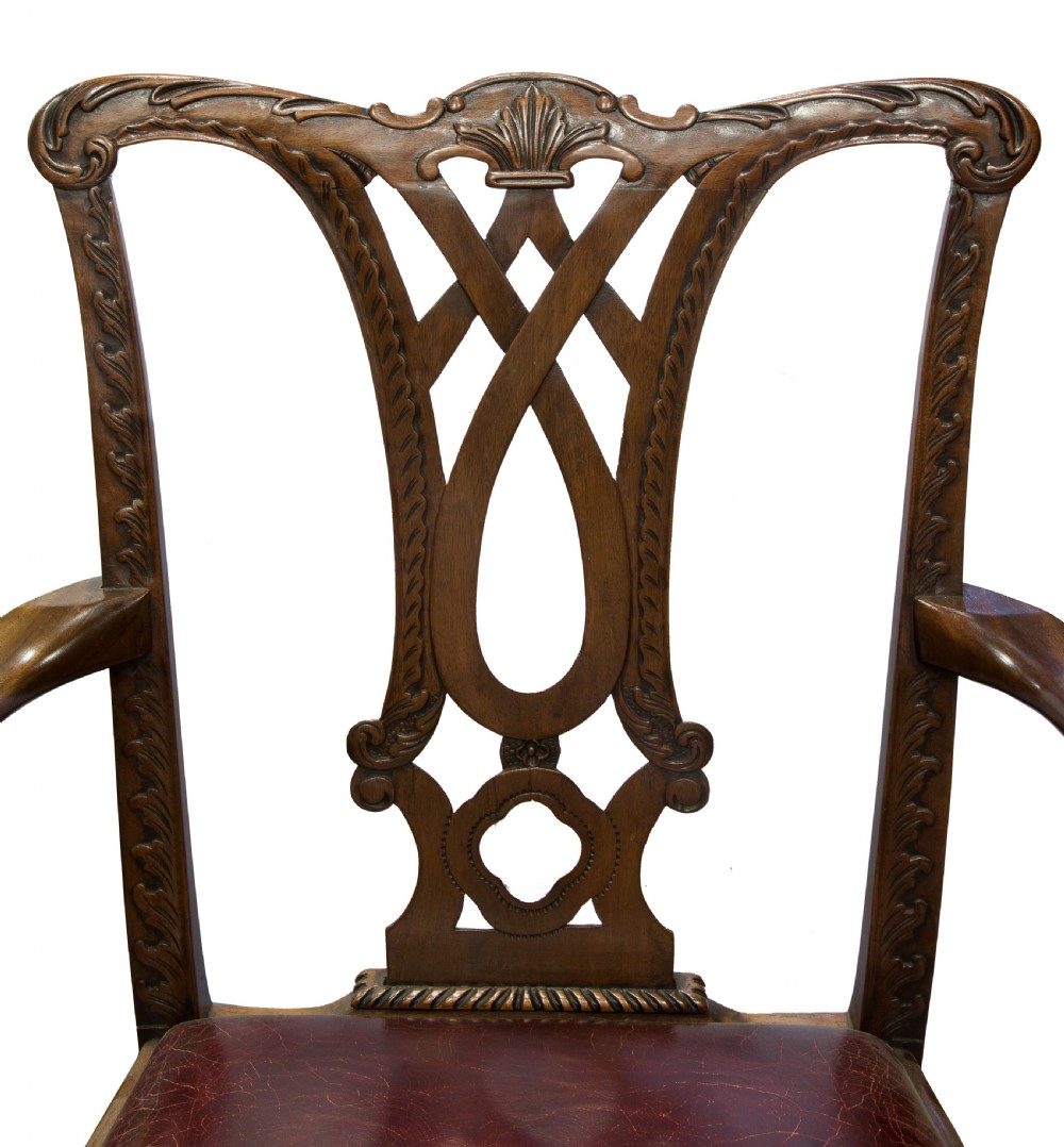 A carved Chippendale style mahogany armchair featuring a pierced back splat, burgundy leather seat, and cabriole legs with ball and claw feet. View V