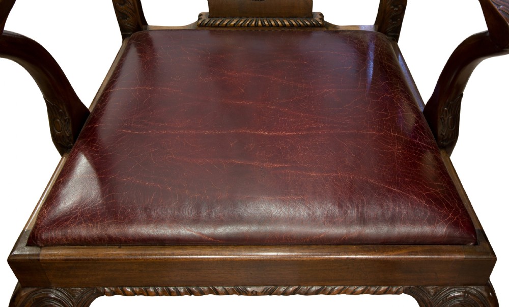 A carved Chippendale style mahogany armchair featuring a pierced back splat, burgundy leather seat, and cabriole legs with ball and claw feet. View VI