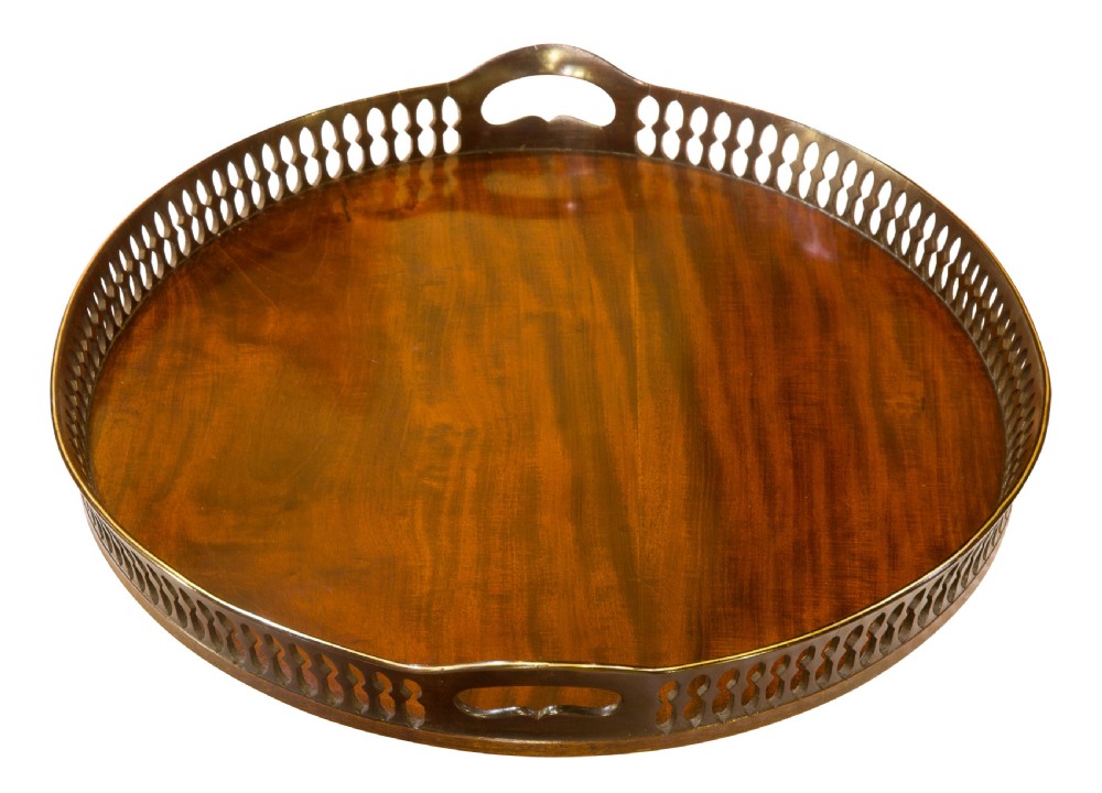 An oval mahogany serving tray with a polished dark wood grain and a raised pierced brass gallery featuring open handle grips. View II