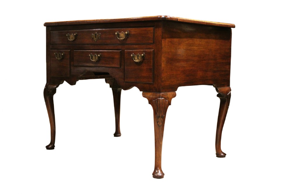 A George II mahogany lowboy table featuring carved cabriole legs, brass drop handles, and four drawers. View II