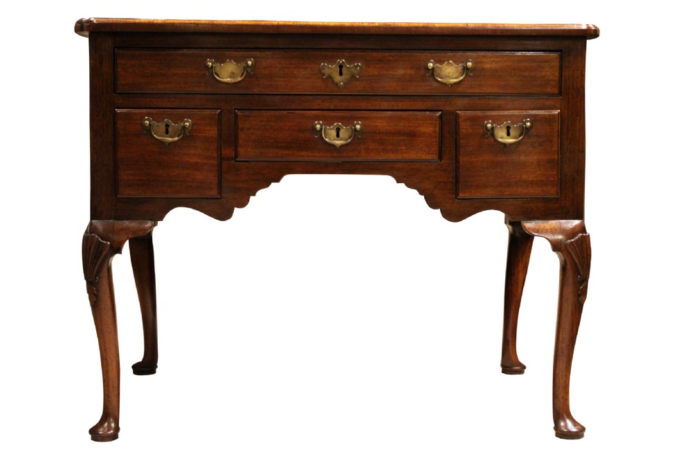 A George II mahogany lowboy table featuring carved cabriole legs, brass drop handles, and four drawers. View III