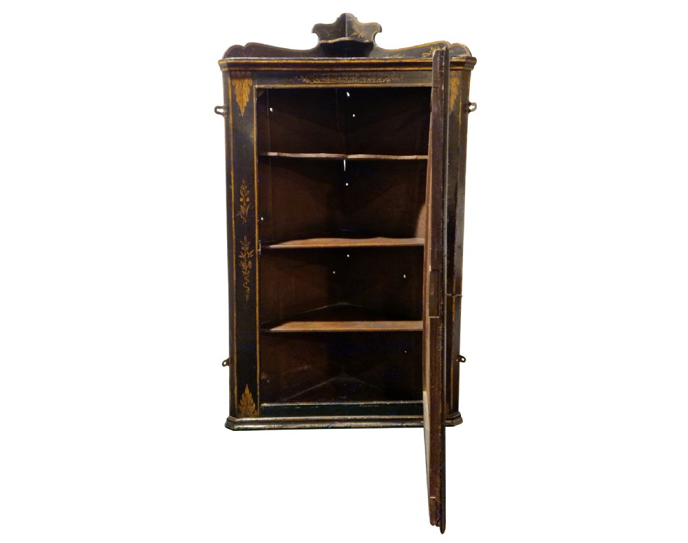 An eighteenth-century black japanned corner cupboard featuring gilded Chinoiserie landscape decorations and ornate brass butterfly hinges. View IV
