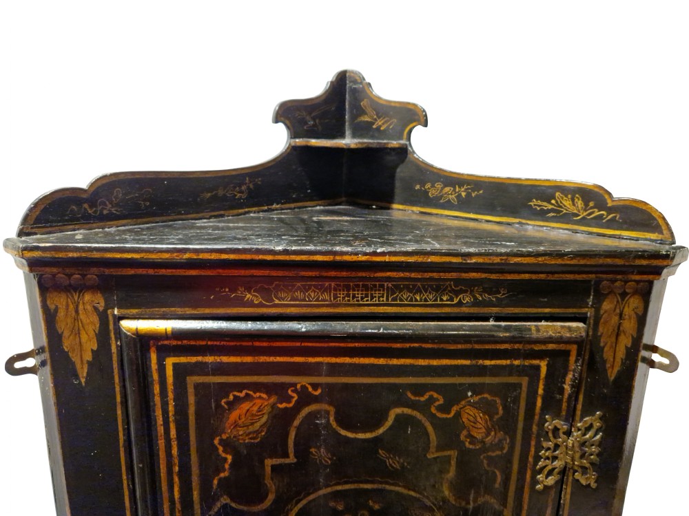 An eighteenth-century black japanned corner cupboard featuring gilded Chinoiserie landscape decorations and ornate brass butterfly hinges. View VI