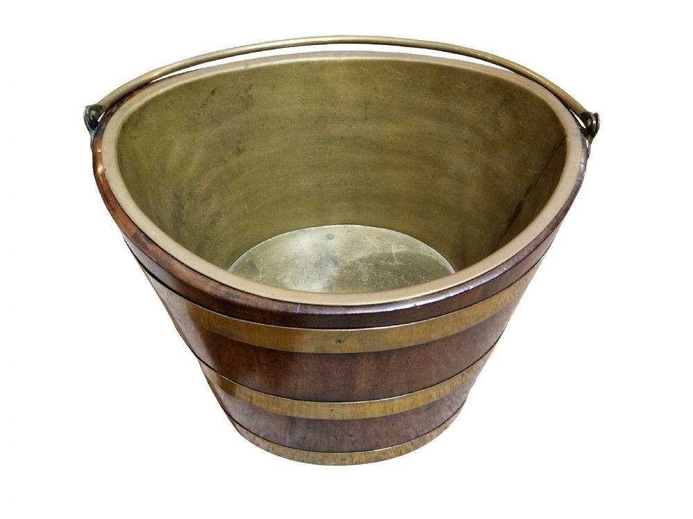 A nineteenth-century tapered mahogany bucket featuring three polished brass bands, a fitted brass interior liner, and a curved top rim. View II