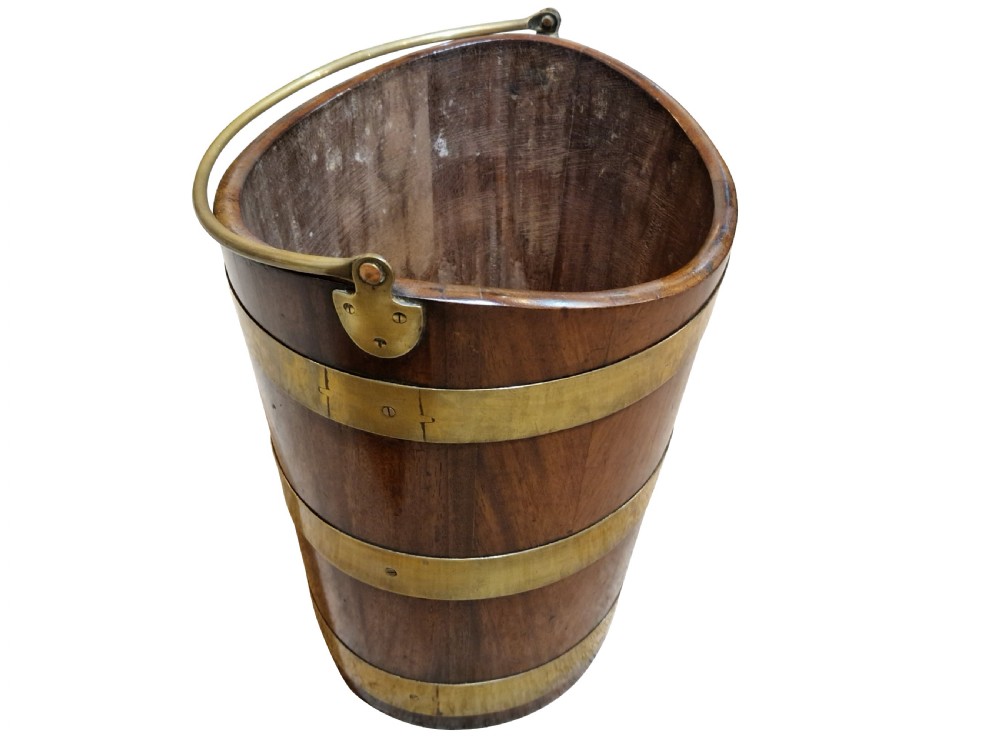 A nineteenth-century tapered mahogany bucket featuring three polished brass bands, a fitted brass interior liner, and a curved top rim. View III