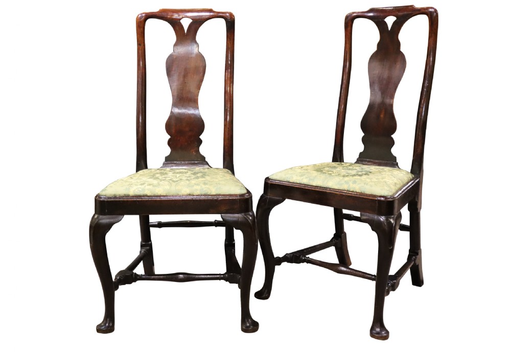 A pair of George I style walnut side chairs featuring high carved backrests with vase splats, cabriole front legs, and green pattern upholstered seats. View II