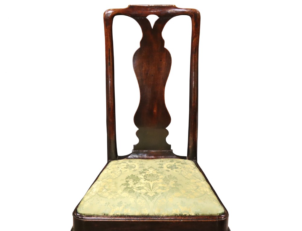 A pair of George I style walnut side chairs featuring high carved backrests with vase splats, cabriole front legs, and green pattern upholstered seats. View VI