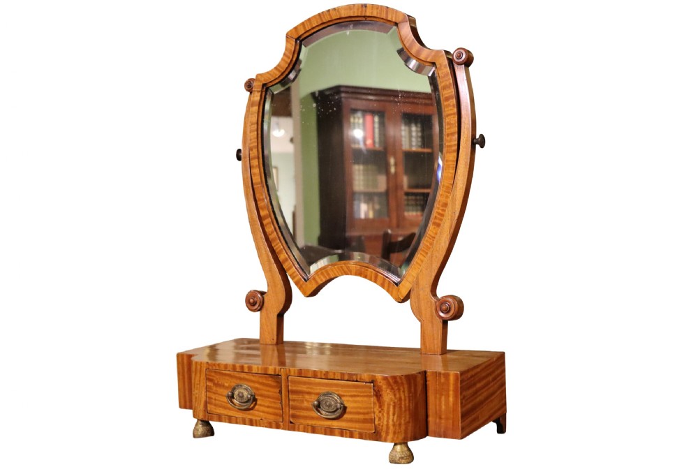 A freestanding antique satinwood dressing table mirror with a shaped bevelled glass frame set above a two-drawer base. View III
