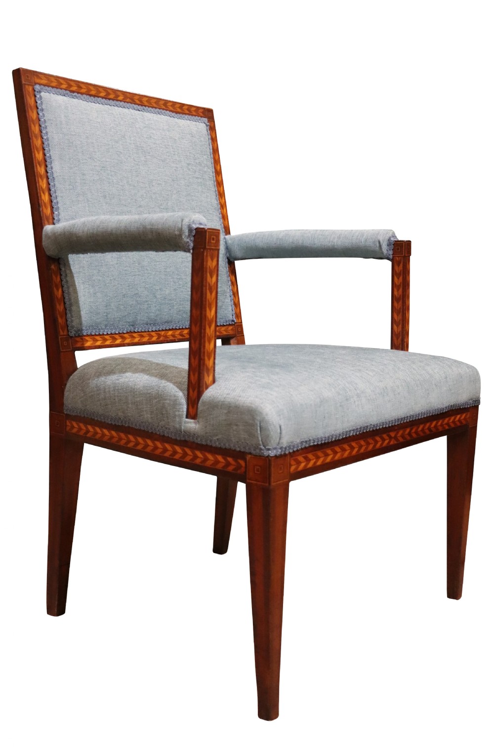 A 19th-century mahogany elbow chair featuring chevron parquetry inlay, padded armrests, square tapered legs, and light blue upholstery. View III
